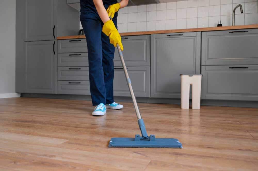 Cleaner mopping a kitchen floor